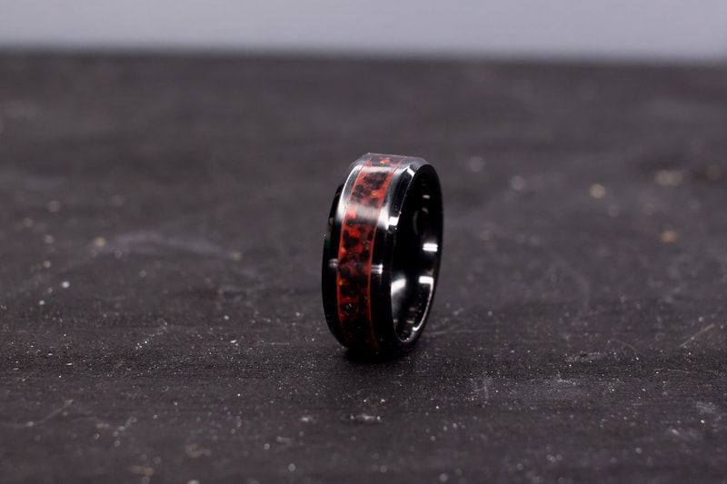 Lava Flow, Black Ceramic ring with red glow powder, jet, and Opals